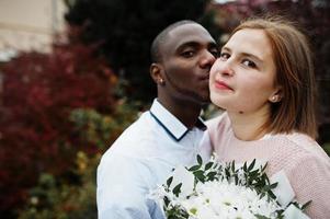 Happy multiethnic couple in love story. Relationships of african man and white european woman. photo