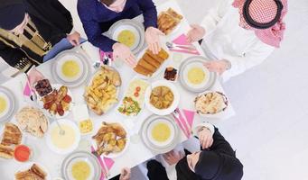 traditional muslim family praying before iftar dinner top view photo