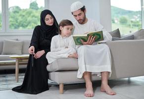 Young muslim family reading Quran during Ramadan photo