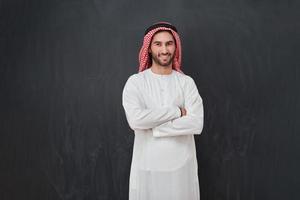 Young muslim man with crossed arms smiling photo