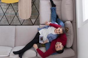 couple relaxing at  home with tablet computers photo