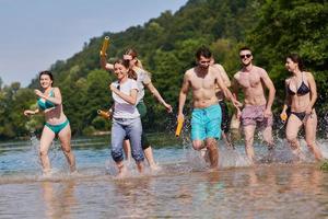 group of happy friends having fun on river photo