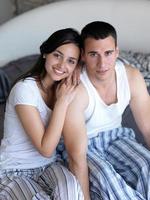 couple relax and have fun in bed photo