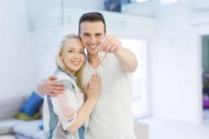couple showing a keys of their new house photo