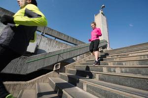 young  couple jogging on steps photo