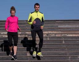 young  couple jogging on steps photo