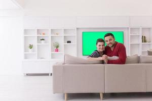 couple hugging and relaxing on sofa photo