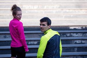 young  couple jogging on steps photo