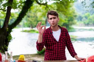 Man putting spices on raw meat  for barbecue grill photo