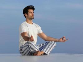 young man practicing yoga photo