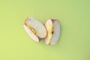 fresh red apple slices on green background photo