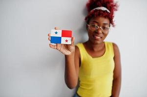 African american woman with afro hair, wear yellow singlet and eyeglasses, hold Panama flag isolated on white background. photo