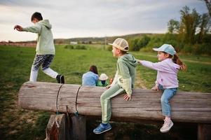 Children having fun together at meadow. photo