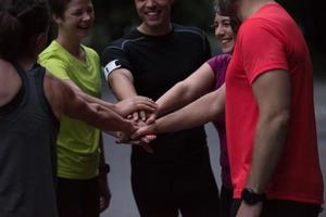 runners giving high five to each other photo