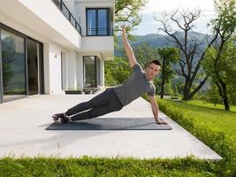 man doing morning yoga exercises photo