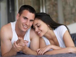 couple relax and have fun in bed photo