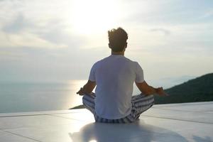 young man practicing yoga photo