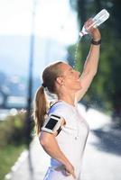 woman drinking  water after  jogging photo