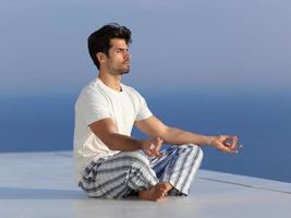 young man practicing yoga photo