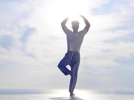 young man practicing yoga photo