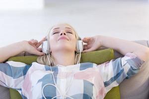 girl enjoying music through headphones photo