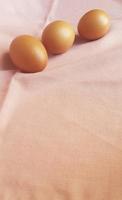 Eggs on a pink cloth. photo