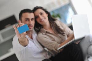 joyful couple relax and work on laptop computer at modern home photo