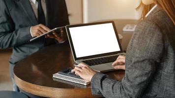 Business documents on office table with smart phone and calculator digital tablet and graph business with social network diagram and two colleagues discussing data working photo