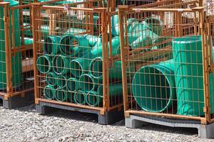a stack of green plastic pipes photo