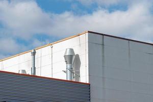 chimney on a roof of an industrial building photo