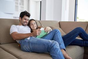 couple at modern home using tablet computer photo