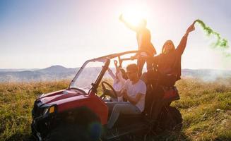 group of young people having fun while driving a off road buggy car photo