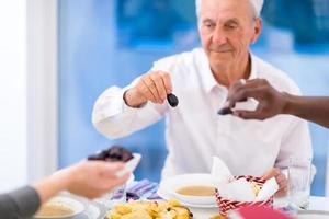 modern multiethnic muslim family sharing a bowl of dates photo