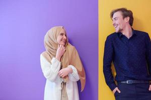 portrait of young muslim couple isolated on colorful background photo