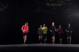 equipo de corredores en el entrenamiento nocturno foto