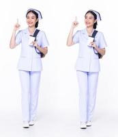 Full length 30s 20s Asian Woman Nurse hospital, pointing finger up in Air, wear formal uniform pant shoes. Smile Hospital female carry backpack coffee cup internet phone over white background isolated photo