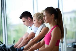 friends  exercising on a treadmill at the bright modern gym photo