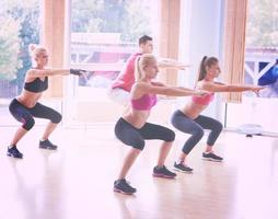 Group of people exercising at the gym photo