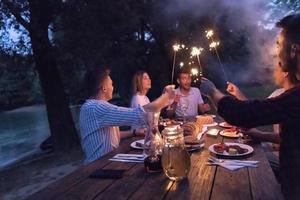 friends having picnic french dinner party outdoor during summer holiday photo