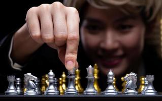 Business woman play Chess with close up Hand. Leader use strategy game to challenge competitor with intelligence leadership to move King to victory with management team idea fight, copy space photo