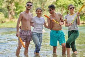 group of happy friends having fun on river photo