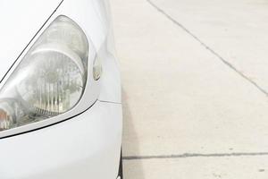 View front of white car on the concrete road. bright light of the bright sky. photo