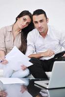 joyful couple relax and work on laptop computer at modern home photo