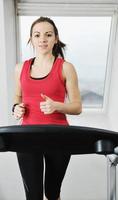 womanworkout  in fitness club on running track machine photo