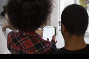 african american couple using tablet at home photo