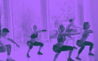 Group of people exercising at the gym photo