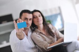 joyful couple relax and work on laptop computer at modern home photo