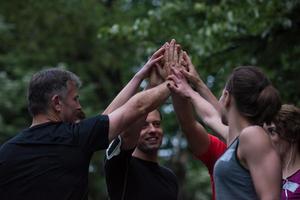 runners giving high five to each other photo