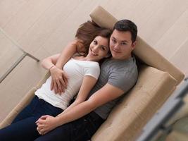 young handsome couple hugging on the sofa photo