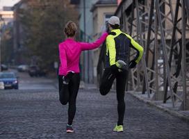 couple warming up before jogging photo